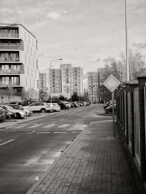 Free A black and white photo of a residential street in Zielona Góra, Poland, depicting urban life. Stock Photo