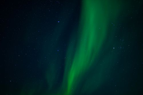 Free Capture of the captivating aurora borealis illuminating the night sky above Nusfjord, Norway. Stock Photo