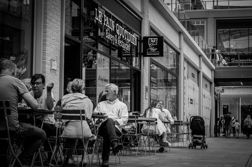 Free Black and white photo of people dining outside a café in Oxford, England. Stock Photo