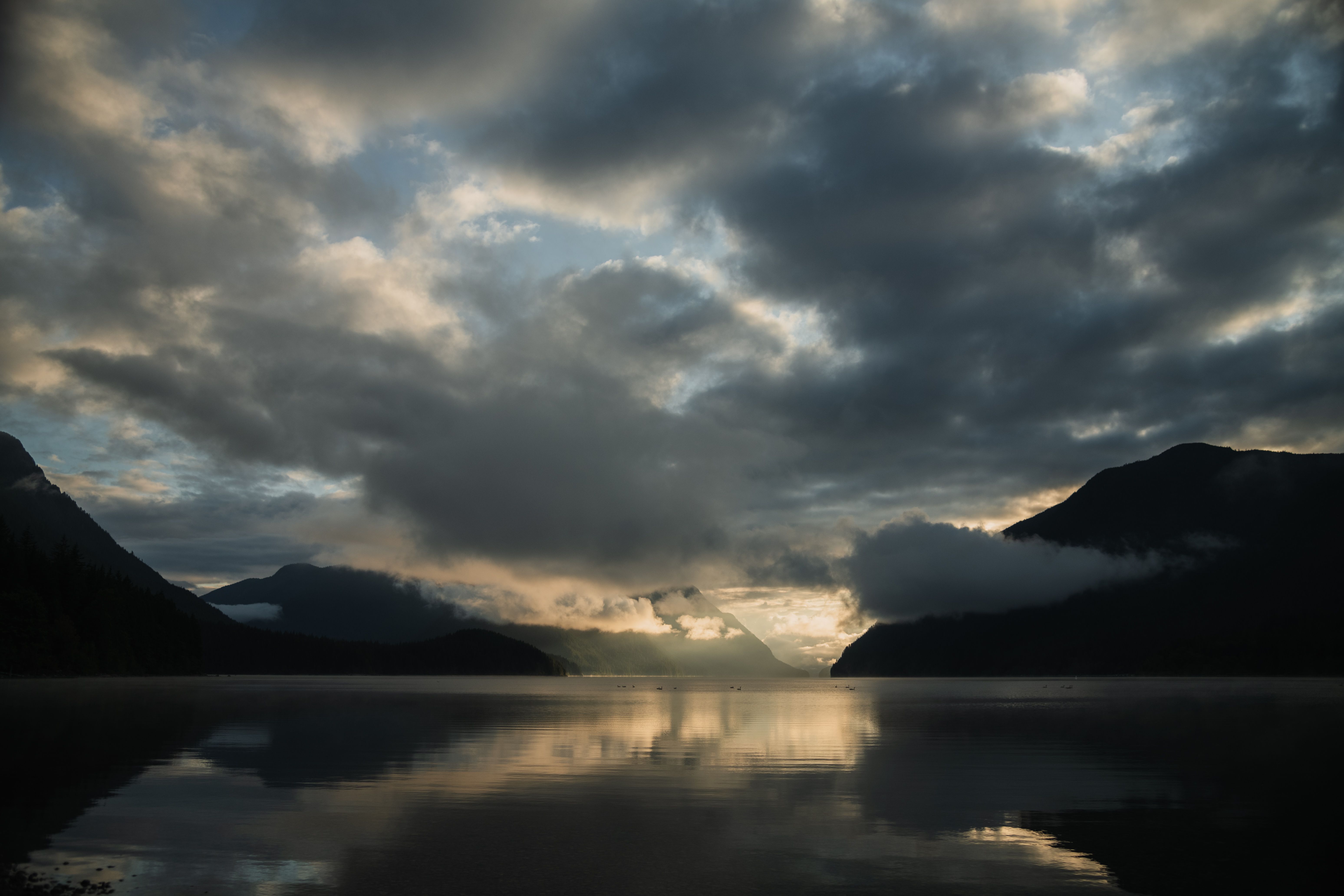 Clouds over Lake and Hills around at Sunset · Free Stock Photo