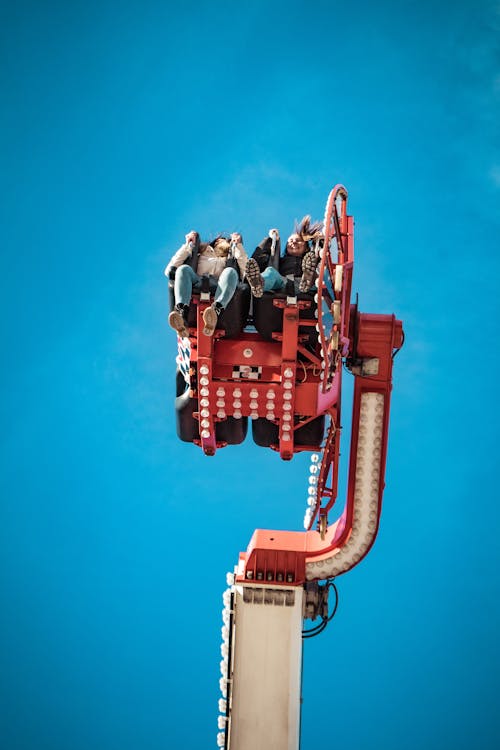 People Rides on Red and Beige Carnival Ride