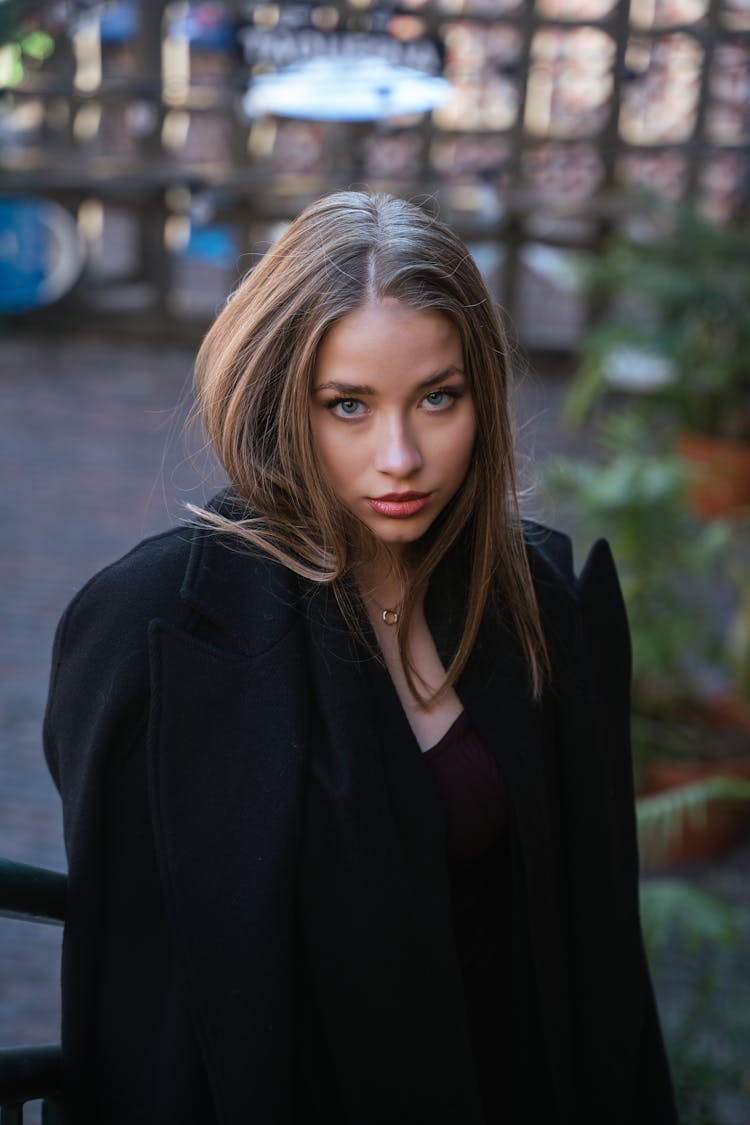 Young Elegant Woman In A Coat Standing Outside 