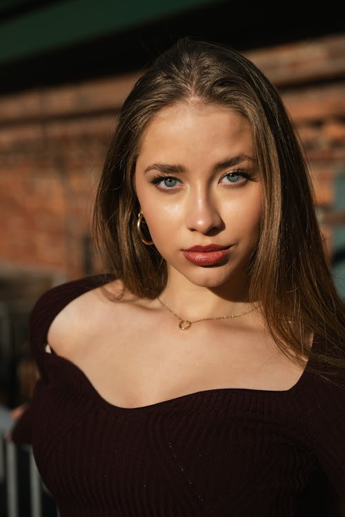 Portrait of a Young Pretty Woman Standing in Sunlight 