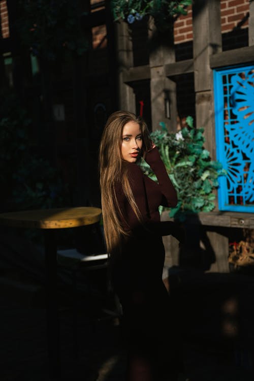 Brunette Woman in Black Dress Posing in Sunlight