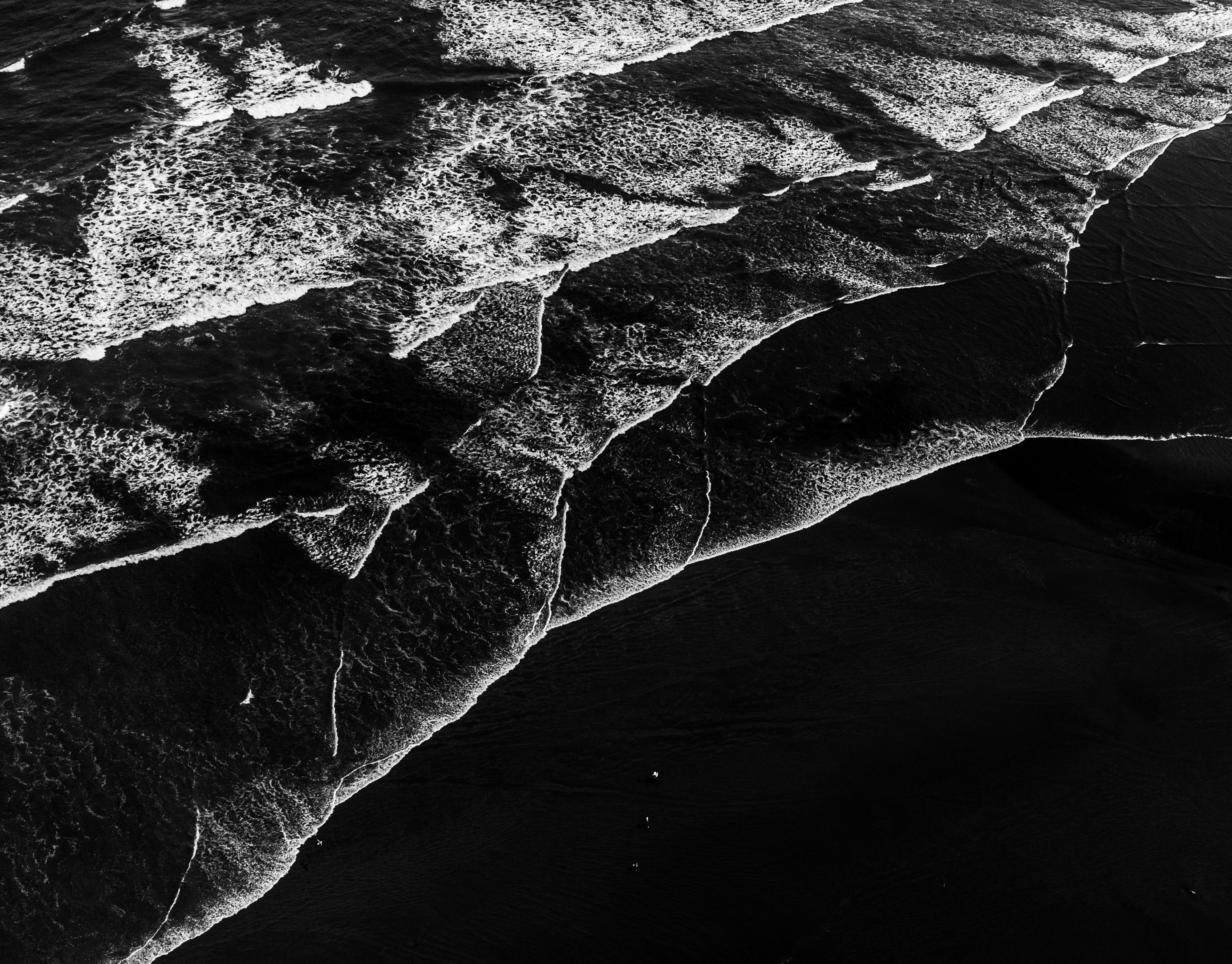 Artistic aerial view of ocean waves on a beach in Rio de Janeiro, Brazil.