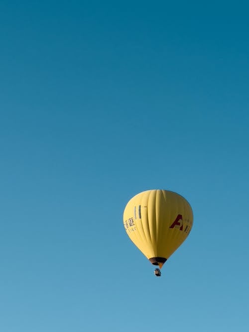 View of a Flying Hot Air Balloon against Blue Sky 