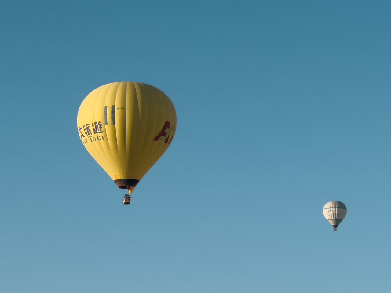 vibrant hot air balloons gently floating in a clear blue sky perfect f