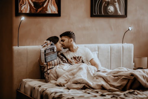 A Couple in Bed with a Radio