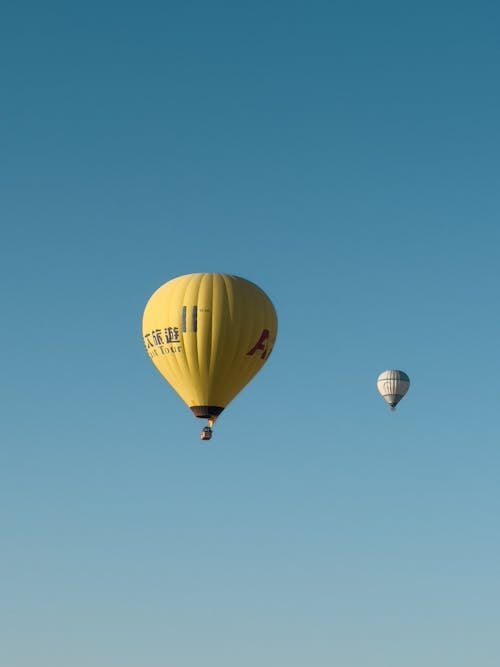 View of Flying Hot Air Balloons against Blue Sky 