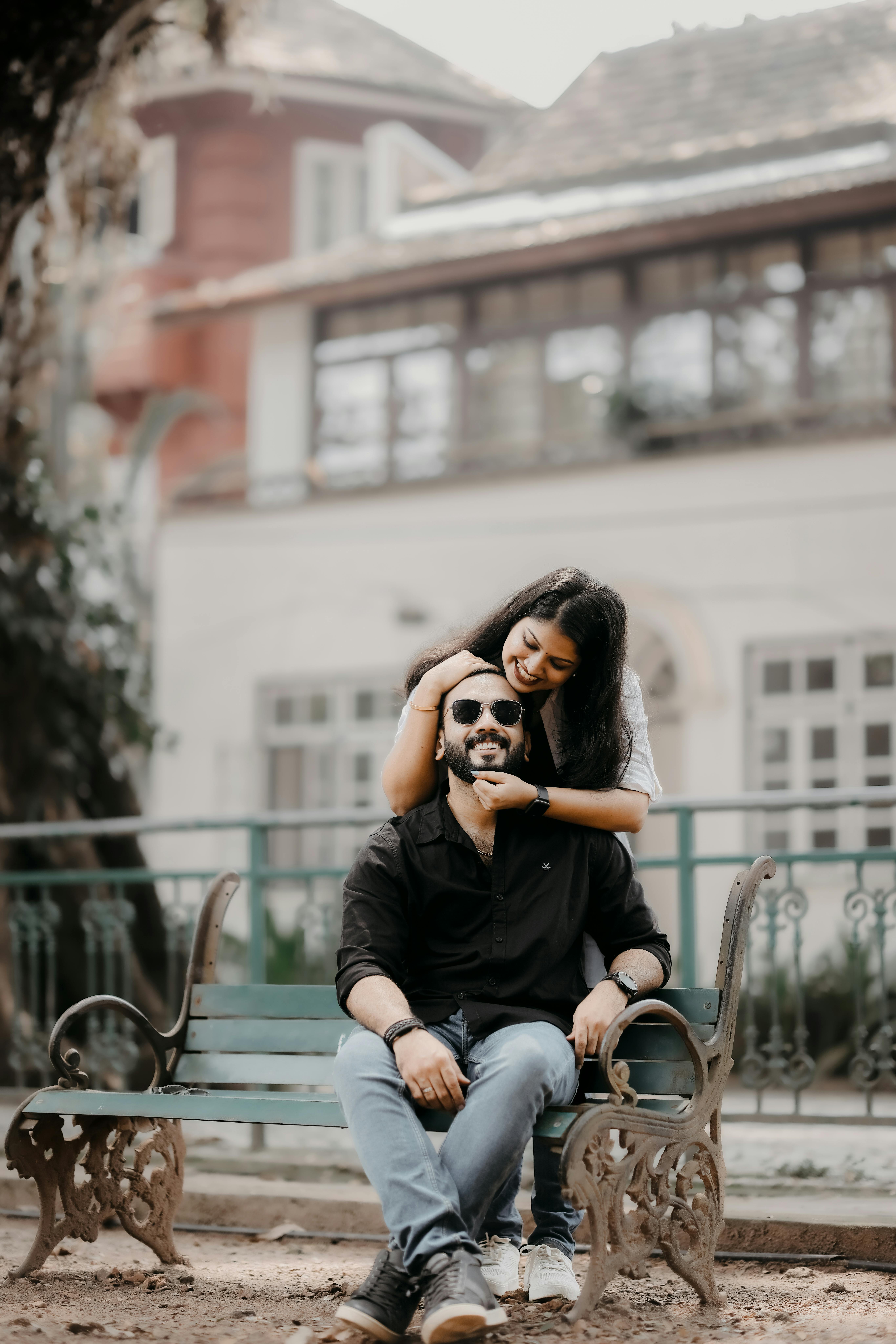 Couple Sitting on Bench Kissing · Free Stock Photo