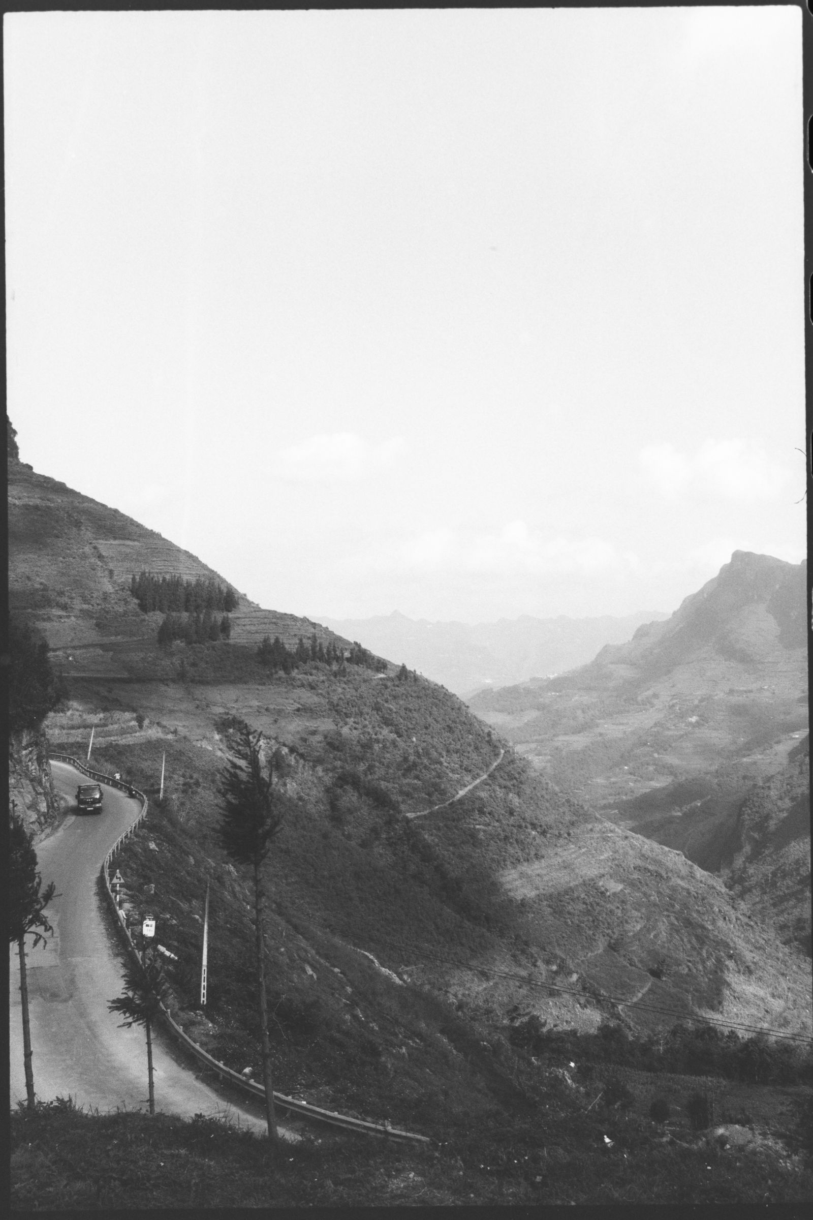 Black and white winding road through Ha Giang mountains showing slow travel instead of mass tourism