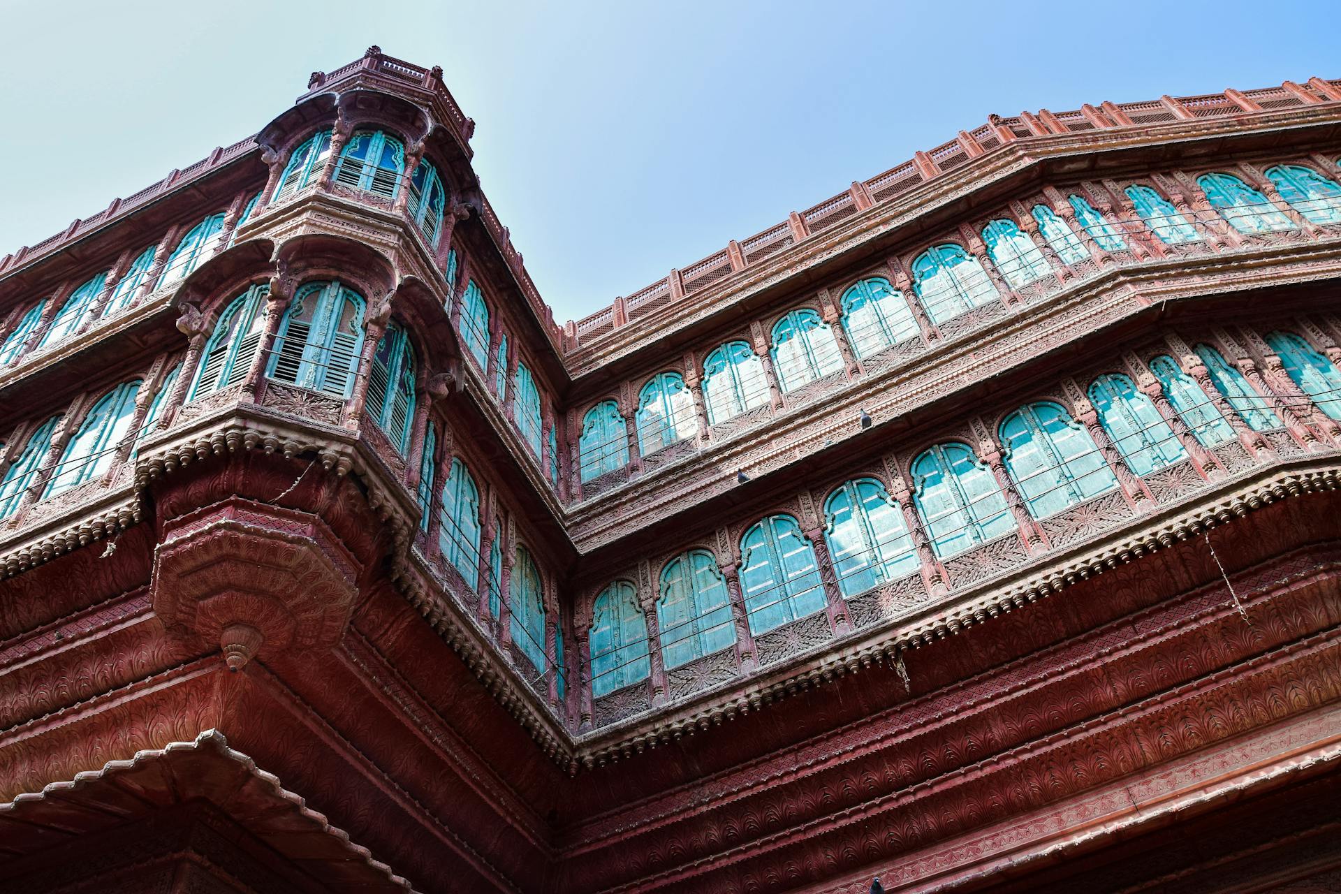 Close-up of an ornate traditional Indian building showcasing intricate design and vibrant colors.