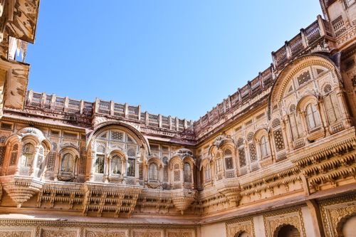 Free Explore the detailed carvings of a historic Indian monument under a bright blue sky. Stock Photo