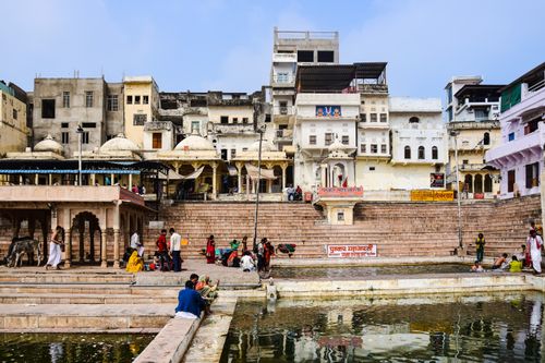 Free Vibrant scene at Pushkar Ghats with traditional architecture and people near the water. Stock Photo