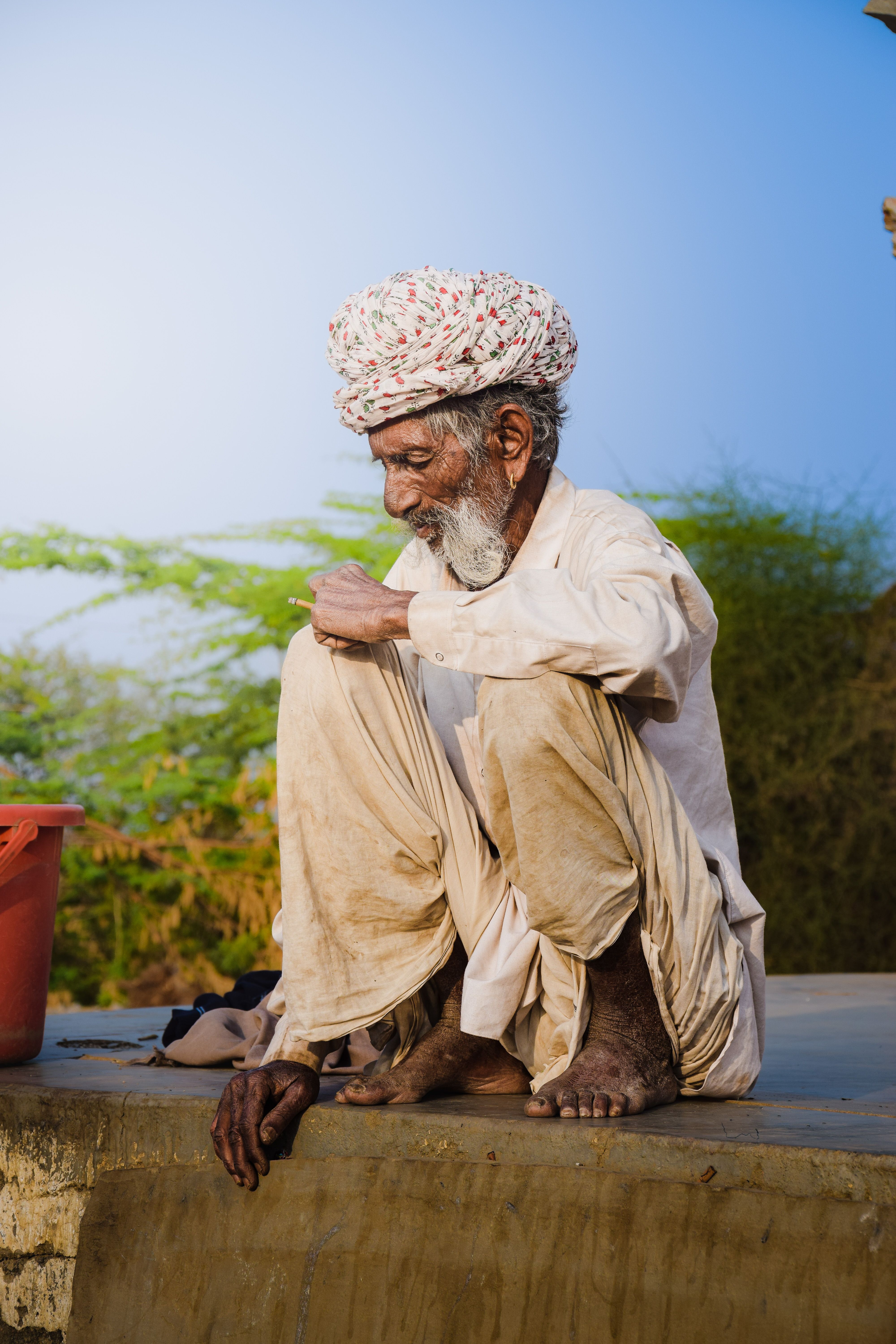 Man Wearing Turban and Gown on a Wall · Free Stock Photo