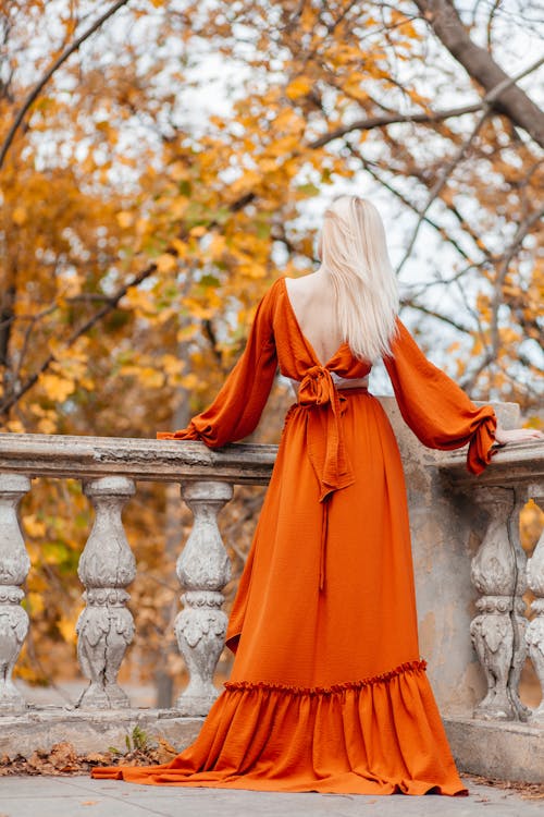 Back View of Blonde Woman in Orange Dress