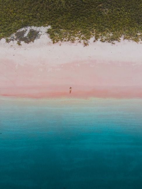 Stunning aerial view of Pink Beach in East Nusa Tenggara, Indonesia with vibrant colors and clear waters.