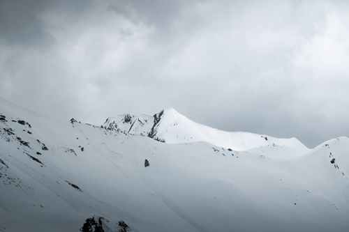 Free A stunning view of snow-covered mountain peaks under cloudy skies in Tux, Tirol, Austria. Stock Photo