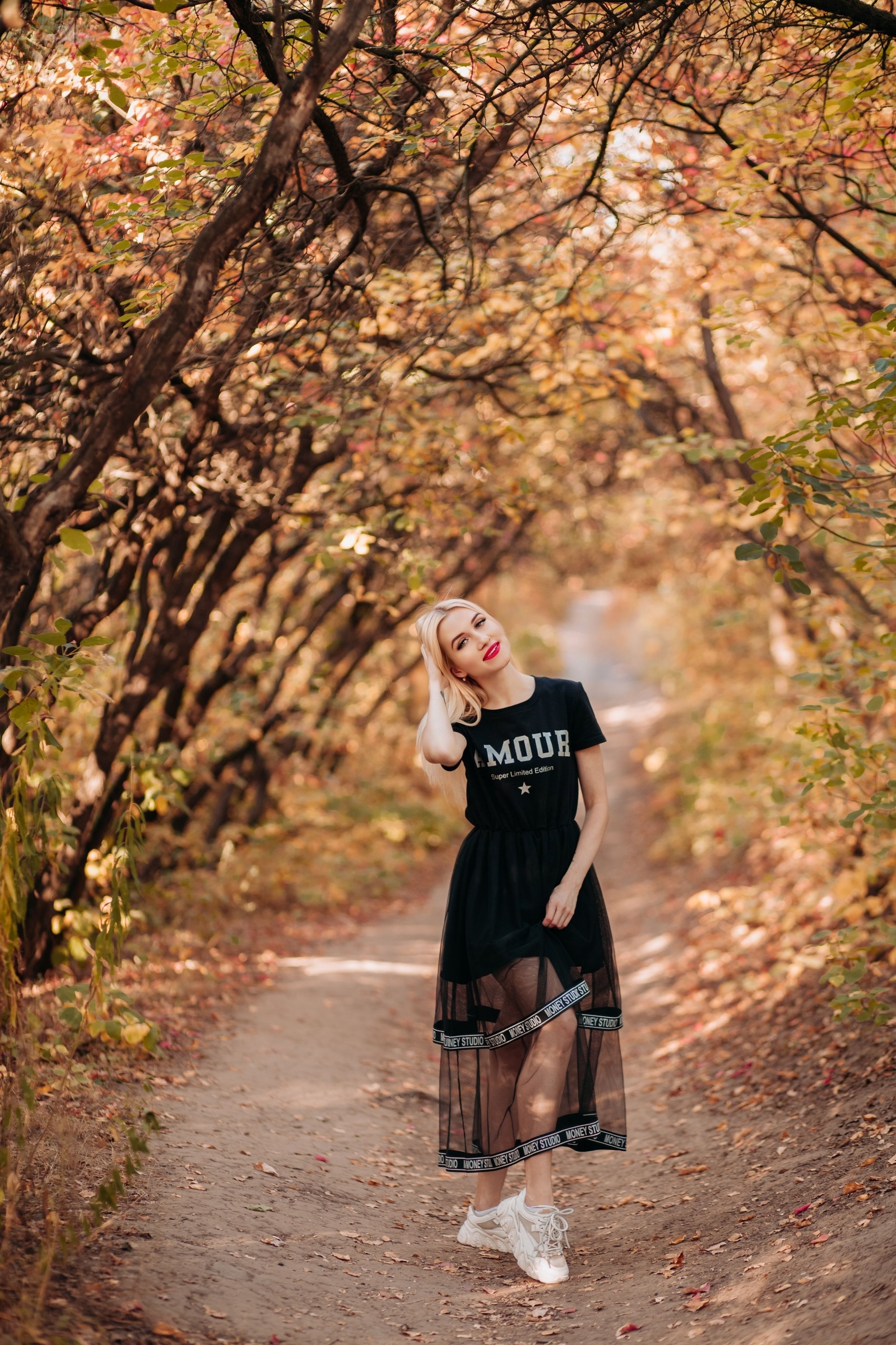 Blonde Woman on a Path in a Forest in Autumn · Free Stock Photo
