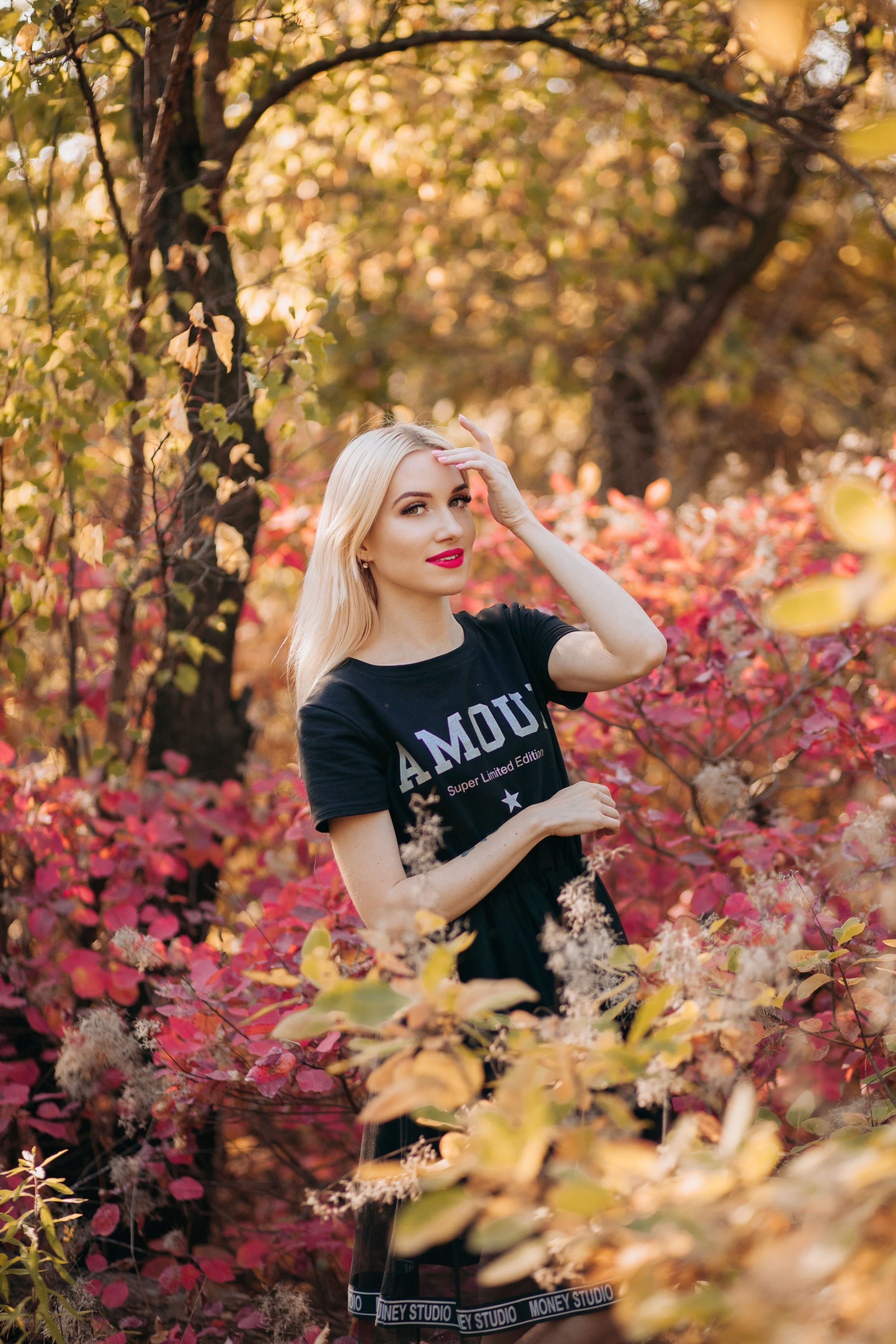 Blonde Woman Posing Among Shrubs · Free Stock Photo