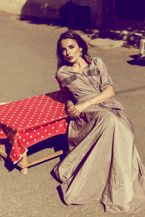 Elegant Woman in a Long Dress Posing Outside in Sunlight 