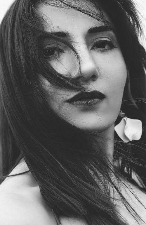 Black and White Portrait of a Woman with Her Hair Blowing in the Wind