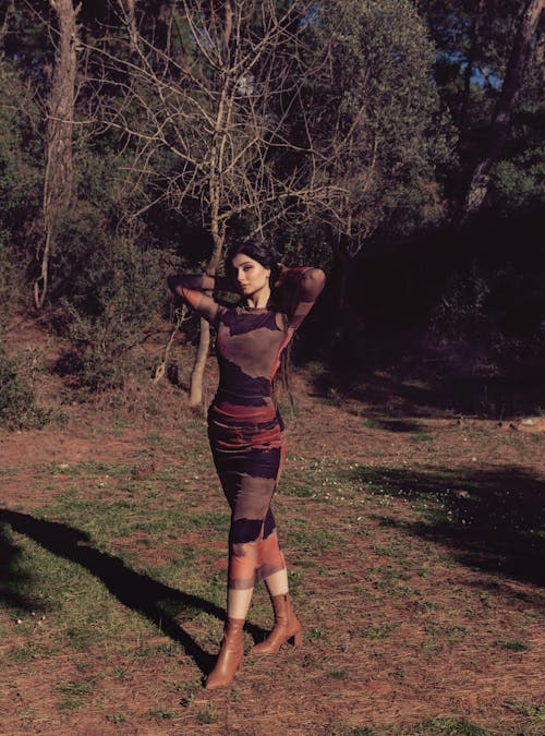 Elegant Woman in a Dress Posing on a Meadow 