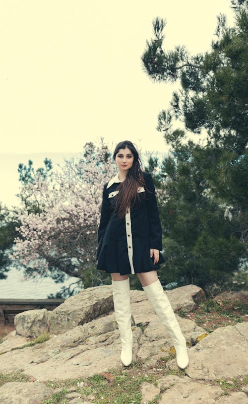 Woman with Black Hair Standing in Boots