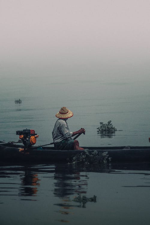 Fisherman on Boat on Foggy Day