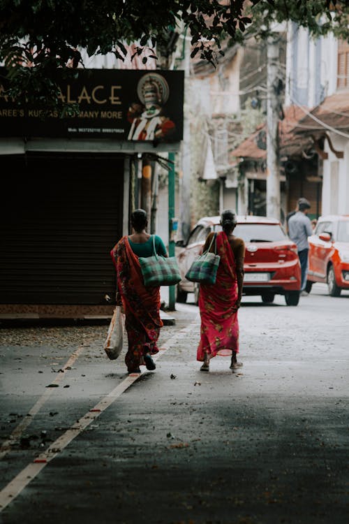 Women Walking with Bags on Street