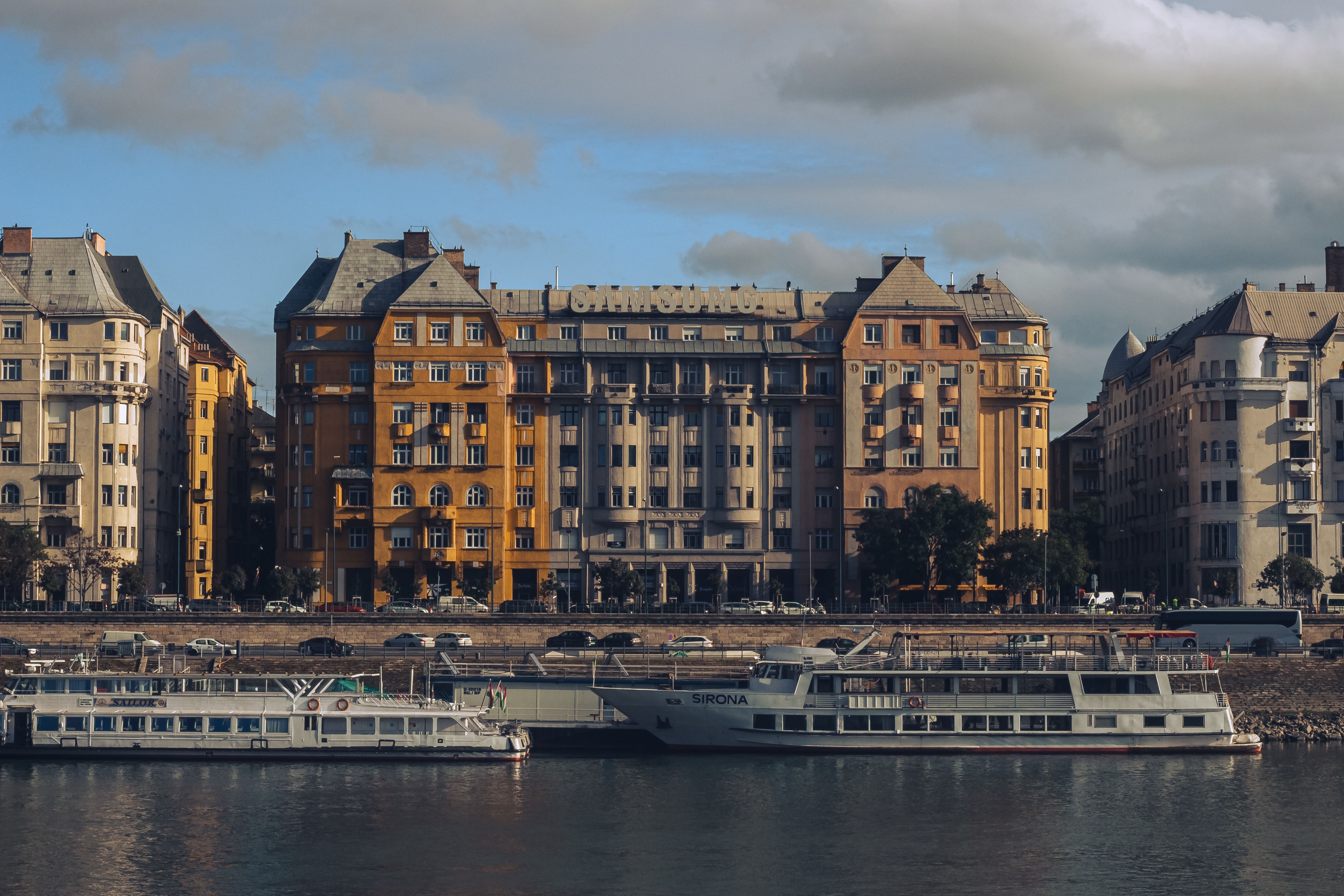Elegant apartment buildings and boats on the Danube River in Budapest, Hungary.