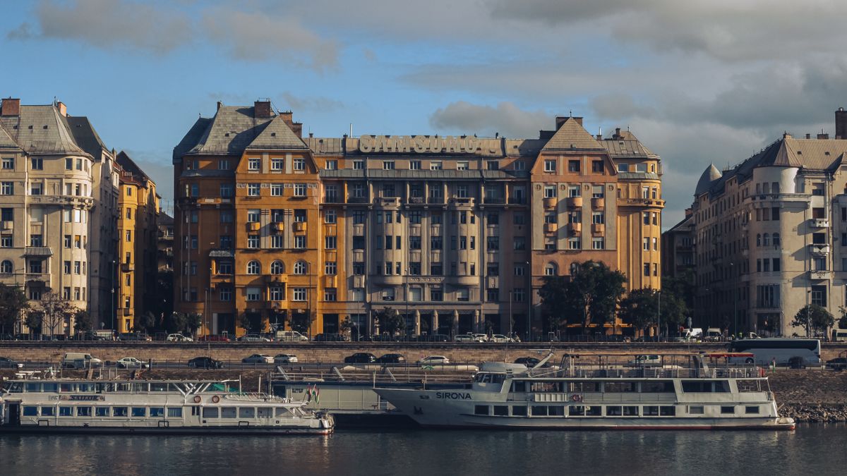 Elegant apartment buildings and boats on the Danube River in Budapest, Hungary.