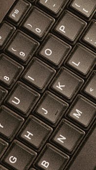 Detailed close-up view of black computer keyboard keys, illustrating modern technology.