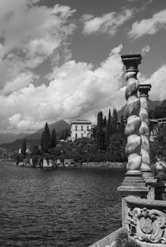 Black and white photograph of Lake Como's coast featuring Villa Monastero.