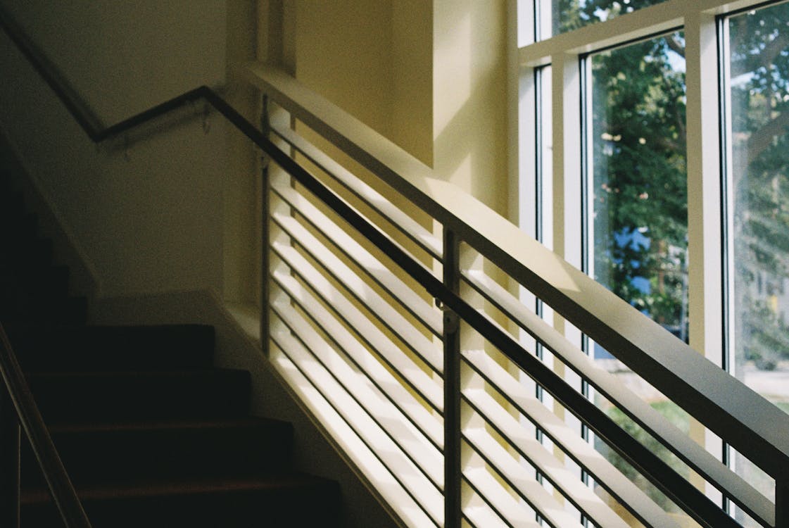 Staircase with Railing by the Window in a Building · Free Stock Photo