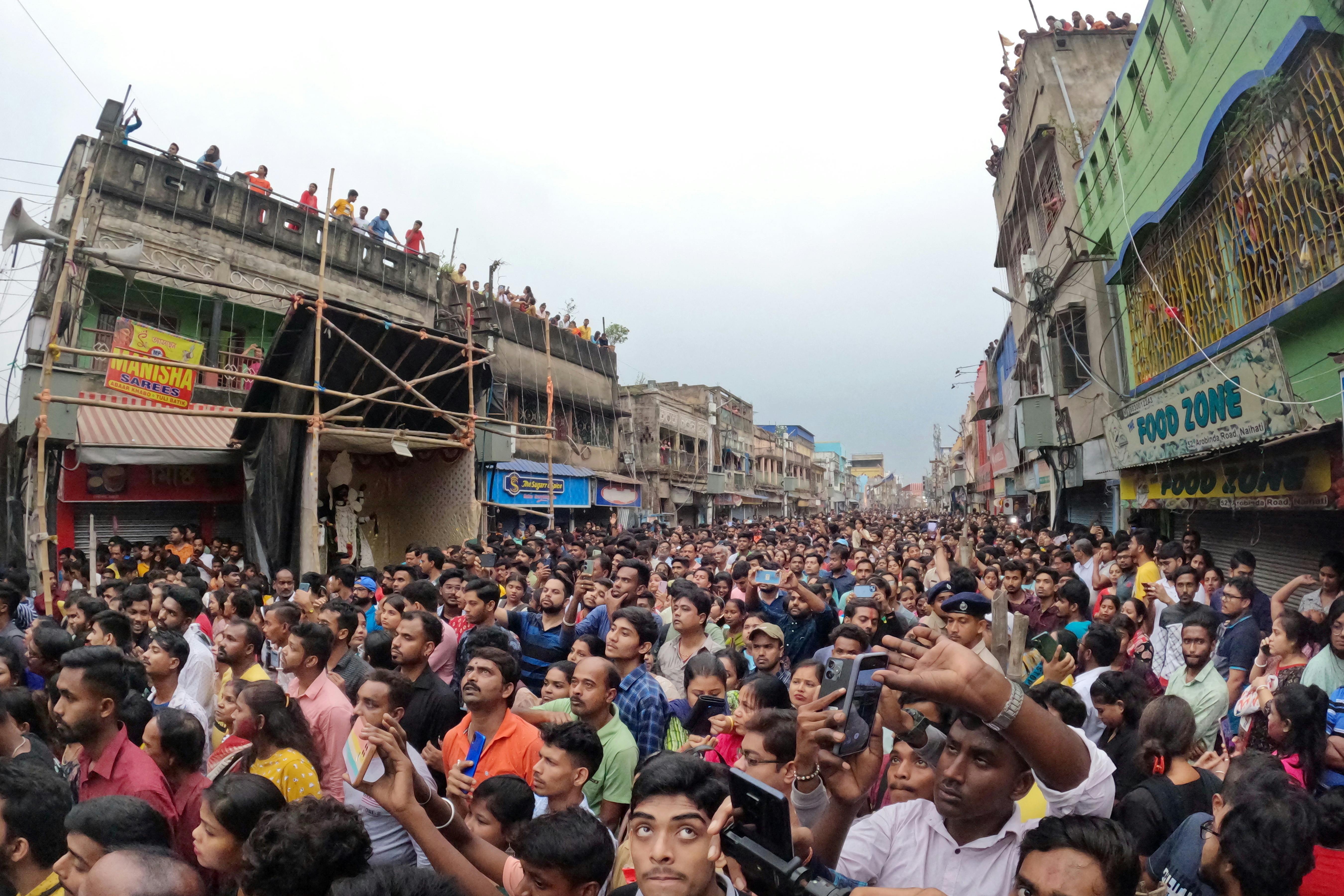 Large crowd gathered during a colorful festival in Naihati, WB, India. Vibrant atmosphere and cultural celebration.