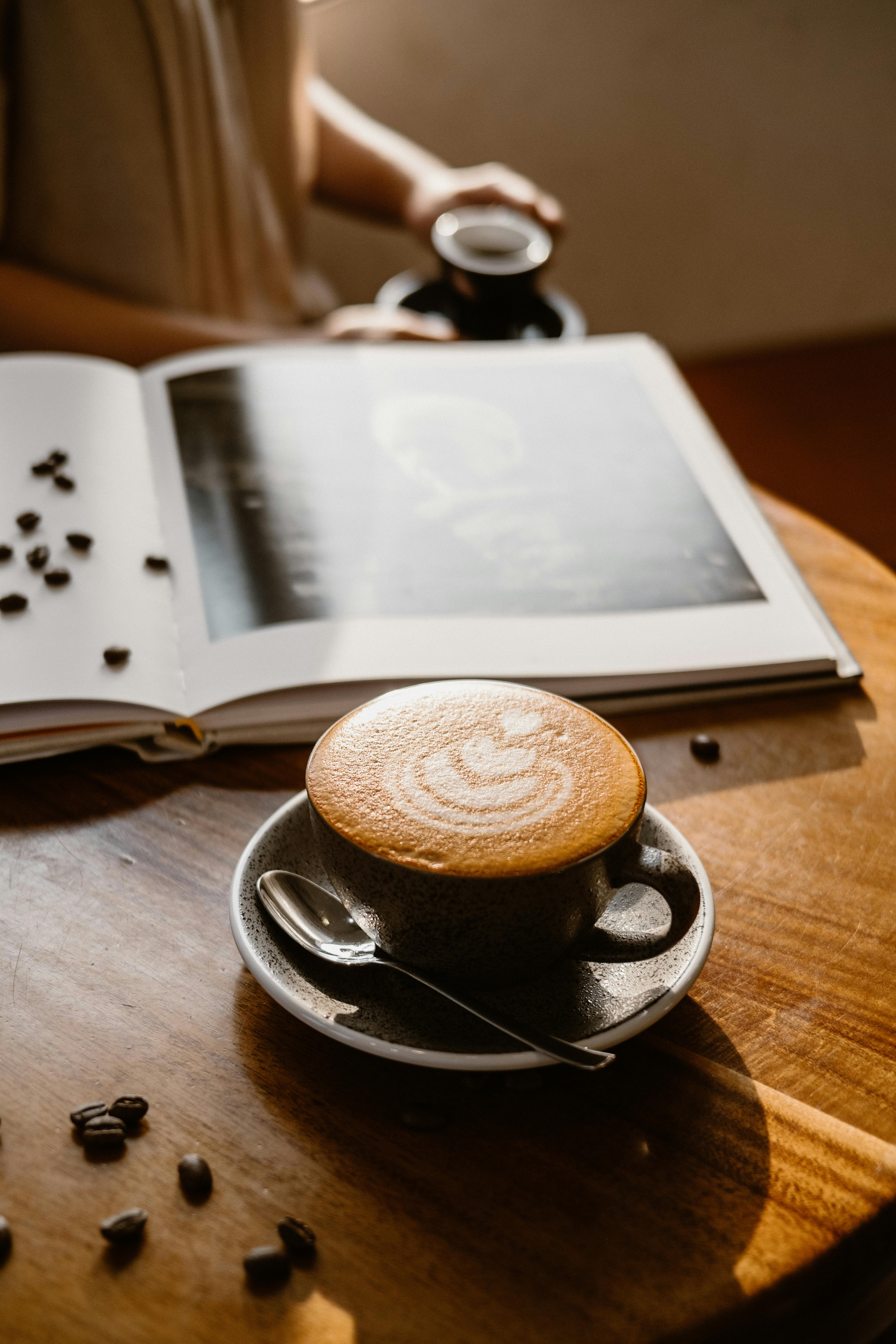 Relax with a cappuccino in a sunlit café, perfect for reading and unwinding.