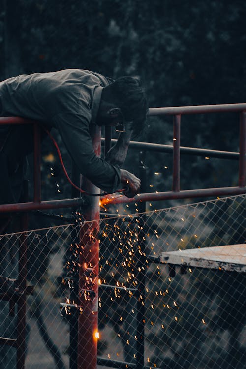 Man Welding Pipes 