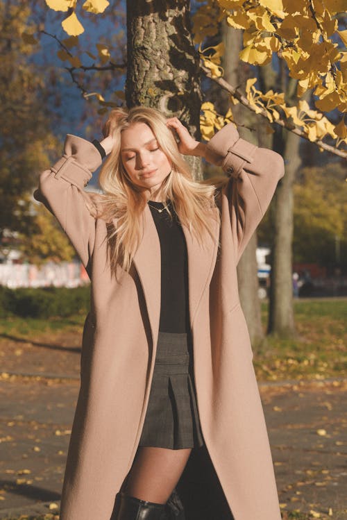 Blonde Woman with Eyes Closed in Coat