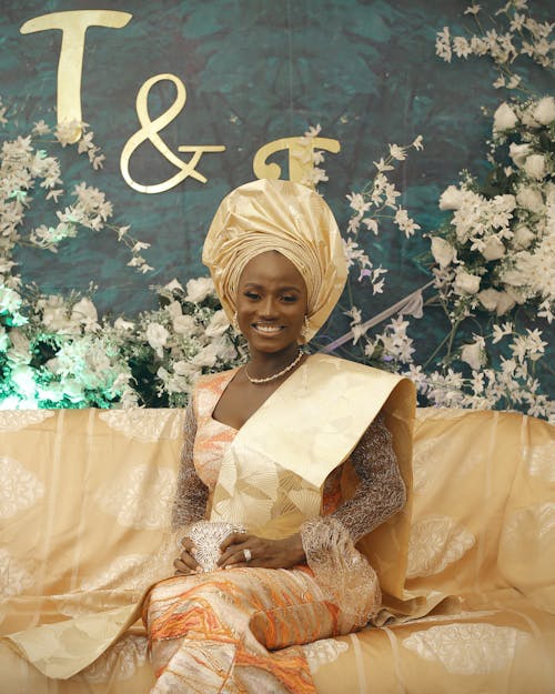 Smiling Woman Sitting in Traditional Clothing