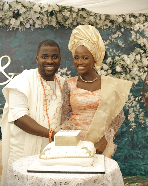 Happy Man and Bride Standing by Cake