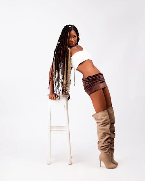 Attractive Woman in White Top and Skirt Posing in Studio