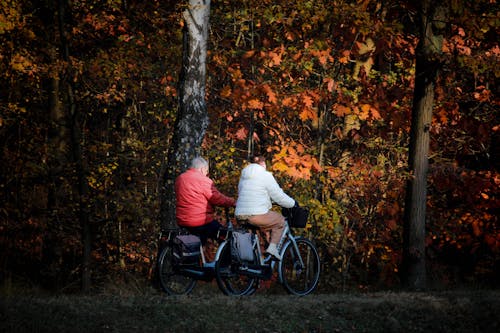 Man and Woman on Bicycles by Forest