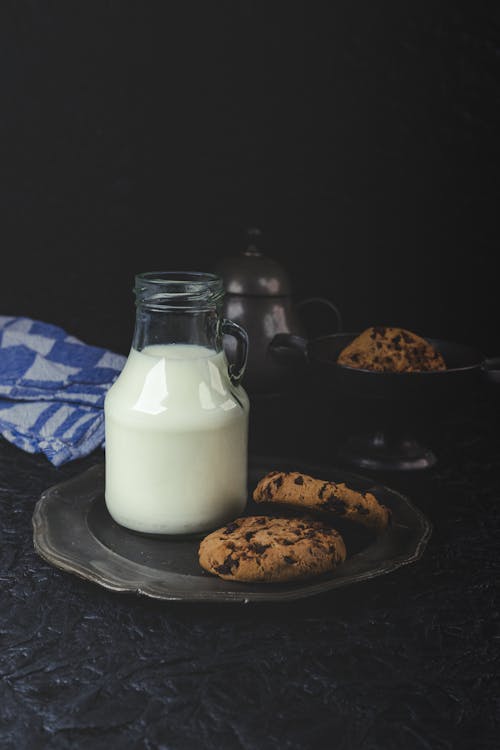 Milk and Chocolate Chip Cookies on Plate