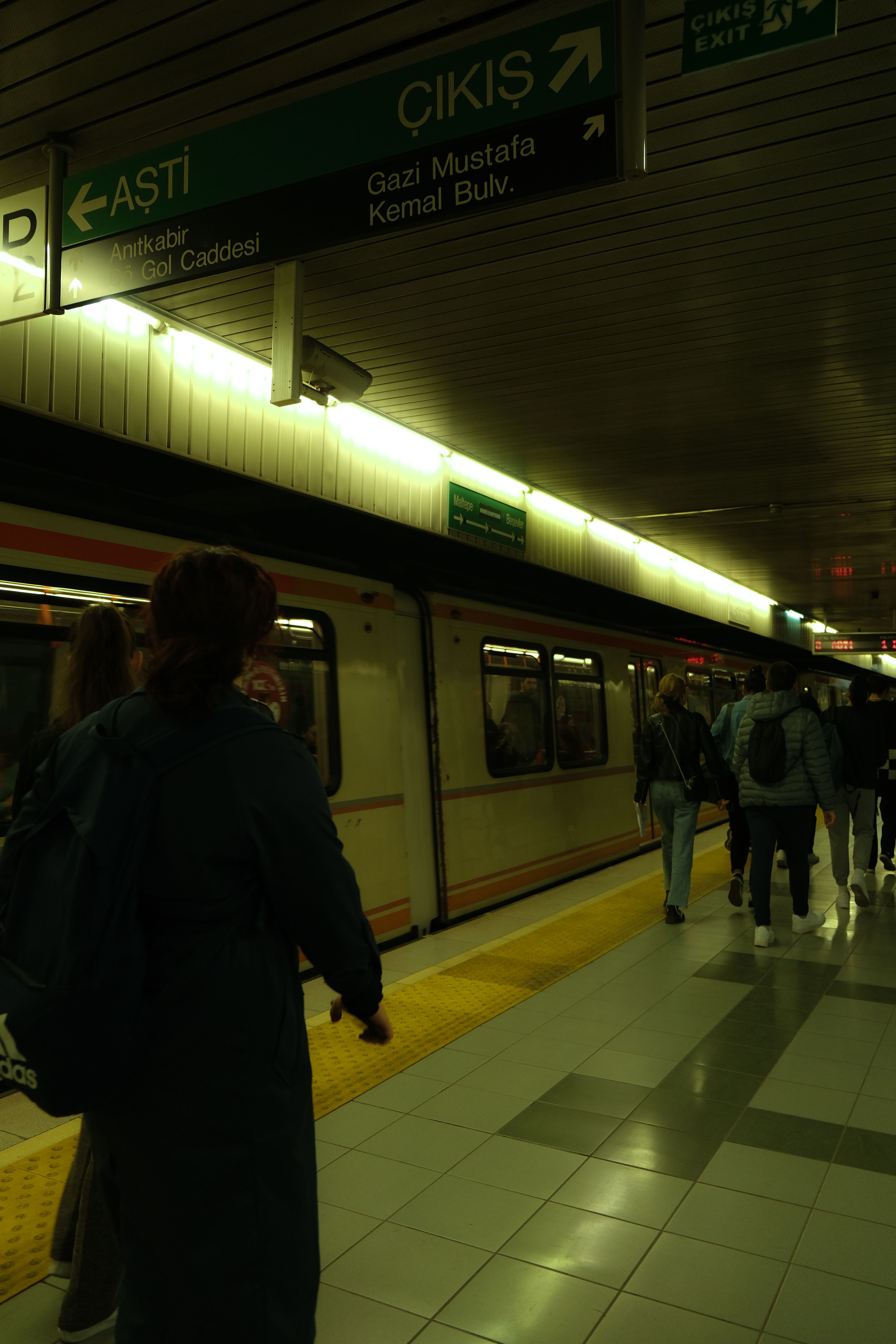 Passengers navigate a bustling subway platform, capturing the essence of public transportation in the city.