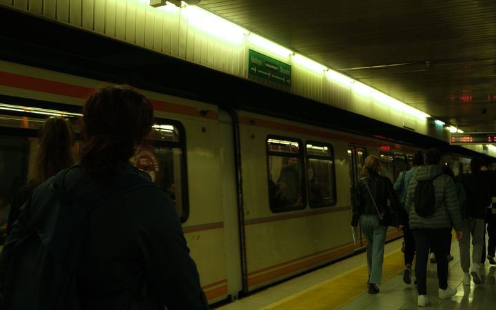 Passengers navigate a bustling subway platform, capturing the essence of public transportation in the city.