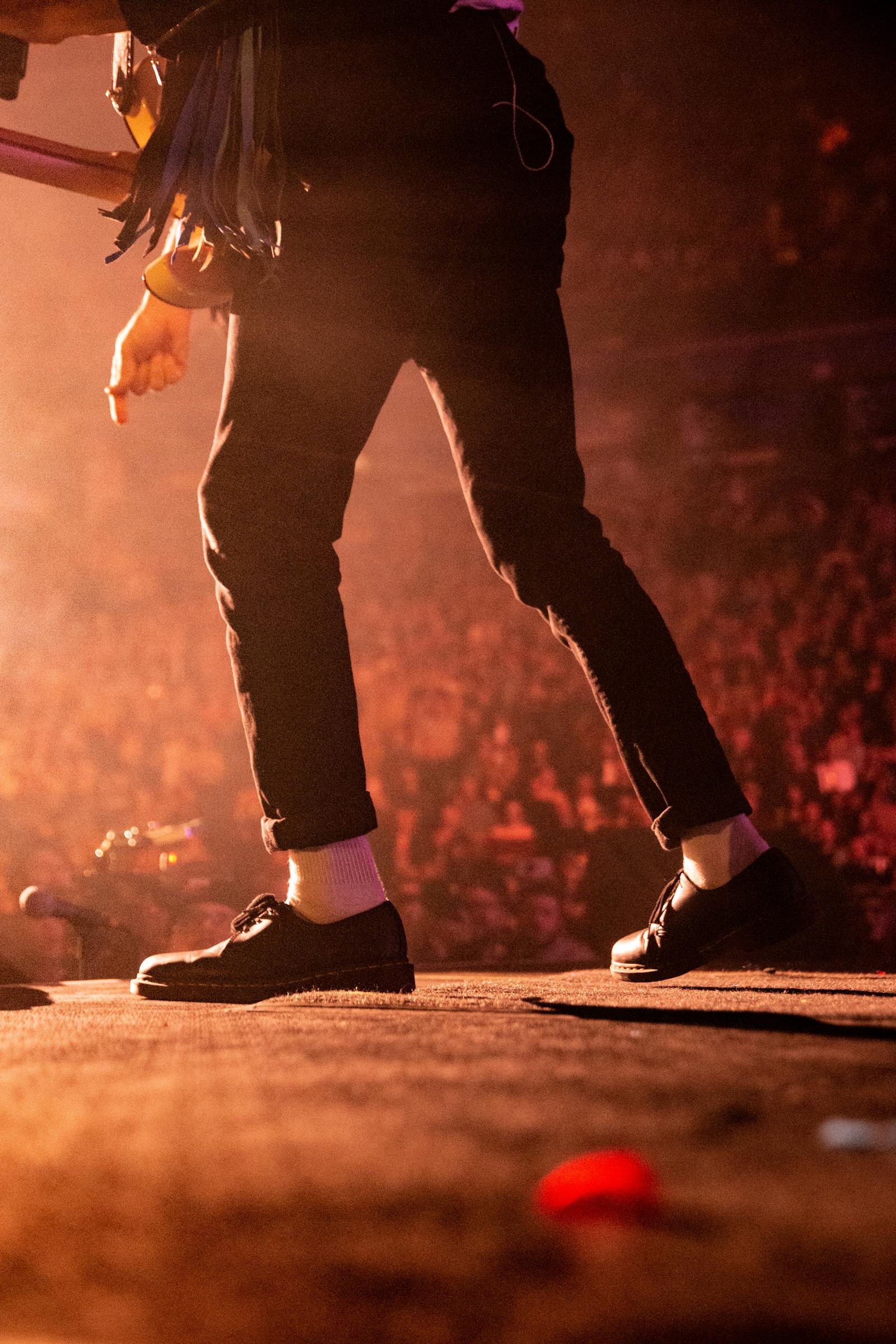 Rock band performing on stage with lights and audience