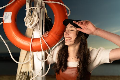 Free A woman is smiling while holding a life preserver Stock Photo