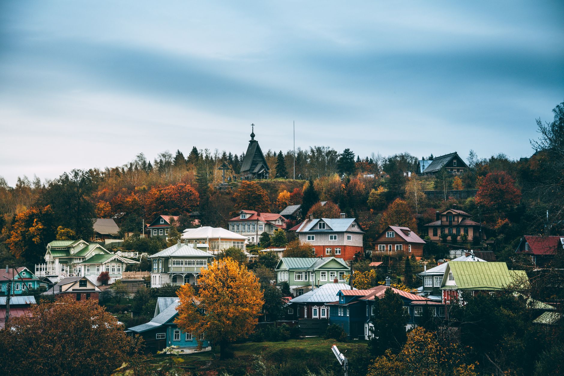 Charming autumn view of the historic town of Ples, Russia with colorful houses and trees.