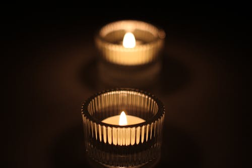 Burning Candles in Glass Jars in Dark
